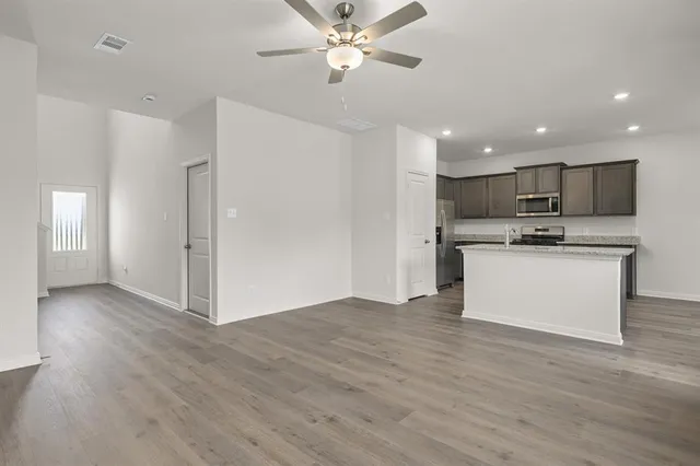 a view of kitchen with refrigerator stove microwave and cabinets