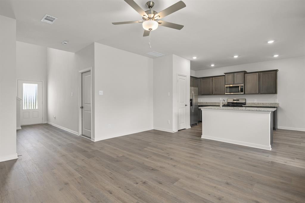 521-a D A D Crain Street Venus, TX 76084 - Photo 10 of 17 a view of kitchen with refrigerator stove microwave and cabinets