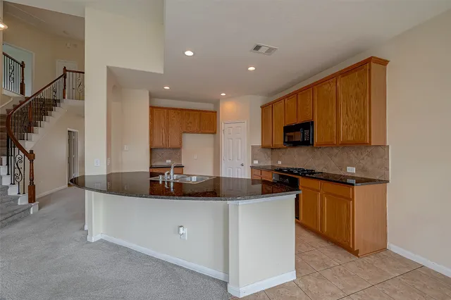 a kitchen with granite countertop cabinets and steel stainless steel appliances