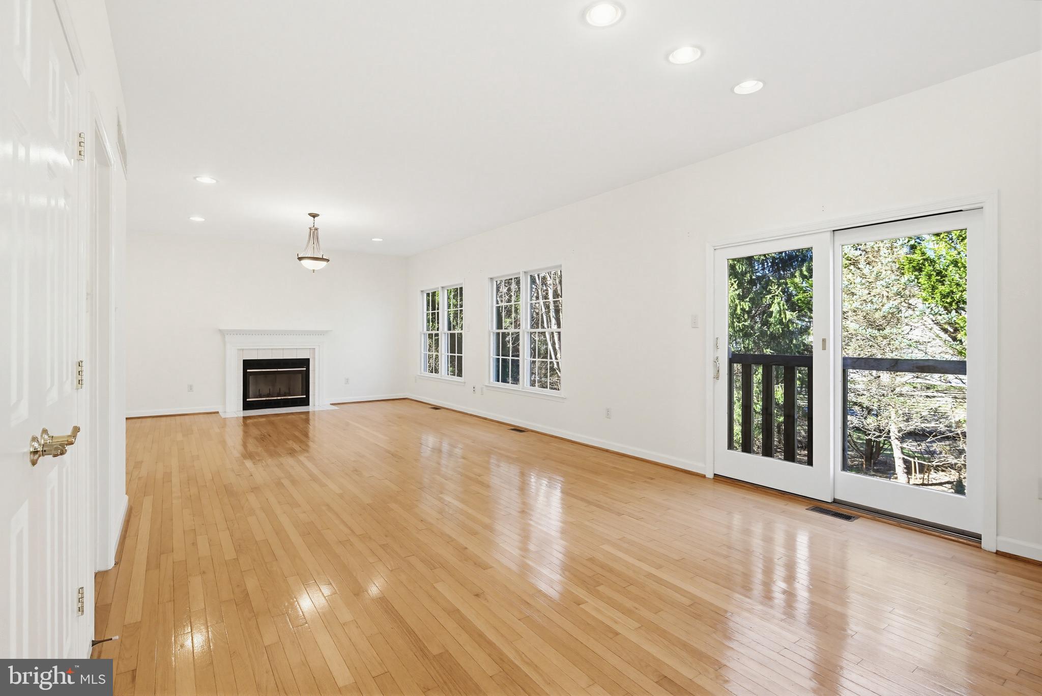 12017 Floating Clouds Path Clarksville, MD 21029 - Photo 31 of 54 an empty room with wooden floor and windows