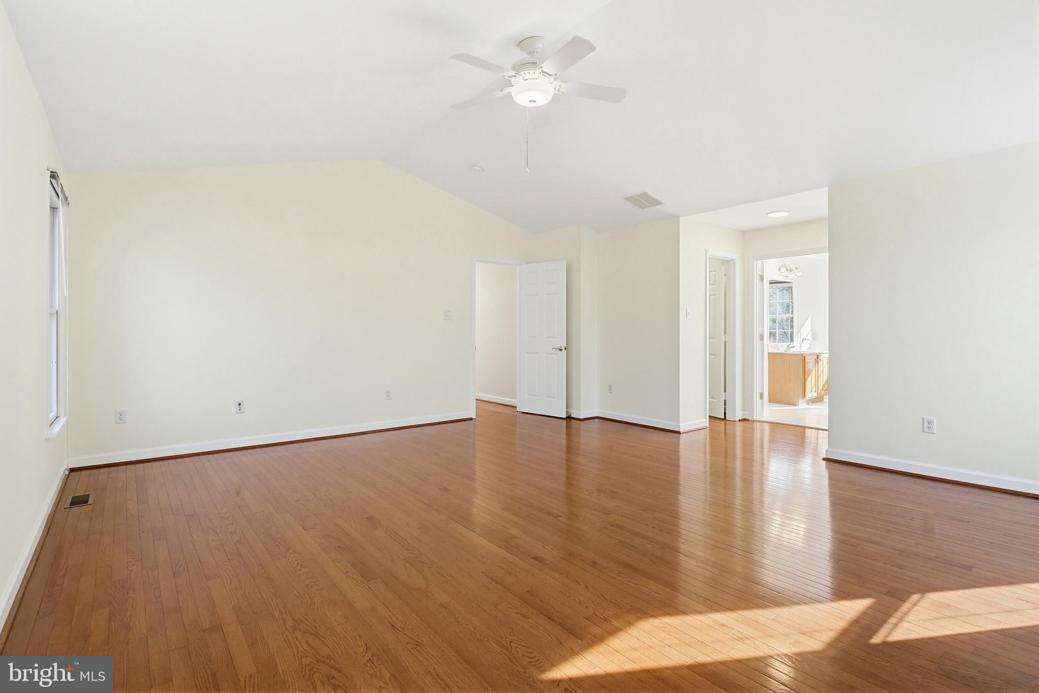 12017 Floating Clouds Path Clarksville, MD 21029 - Photo 33 of 54 an empty room with wooden floor and windows