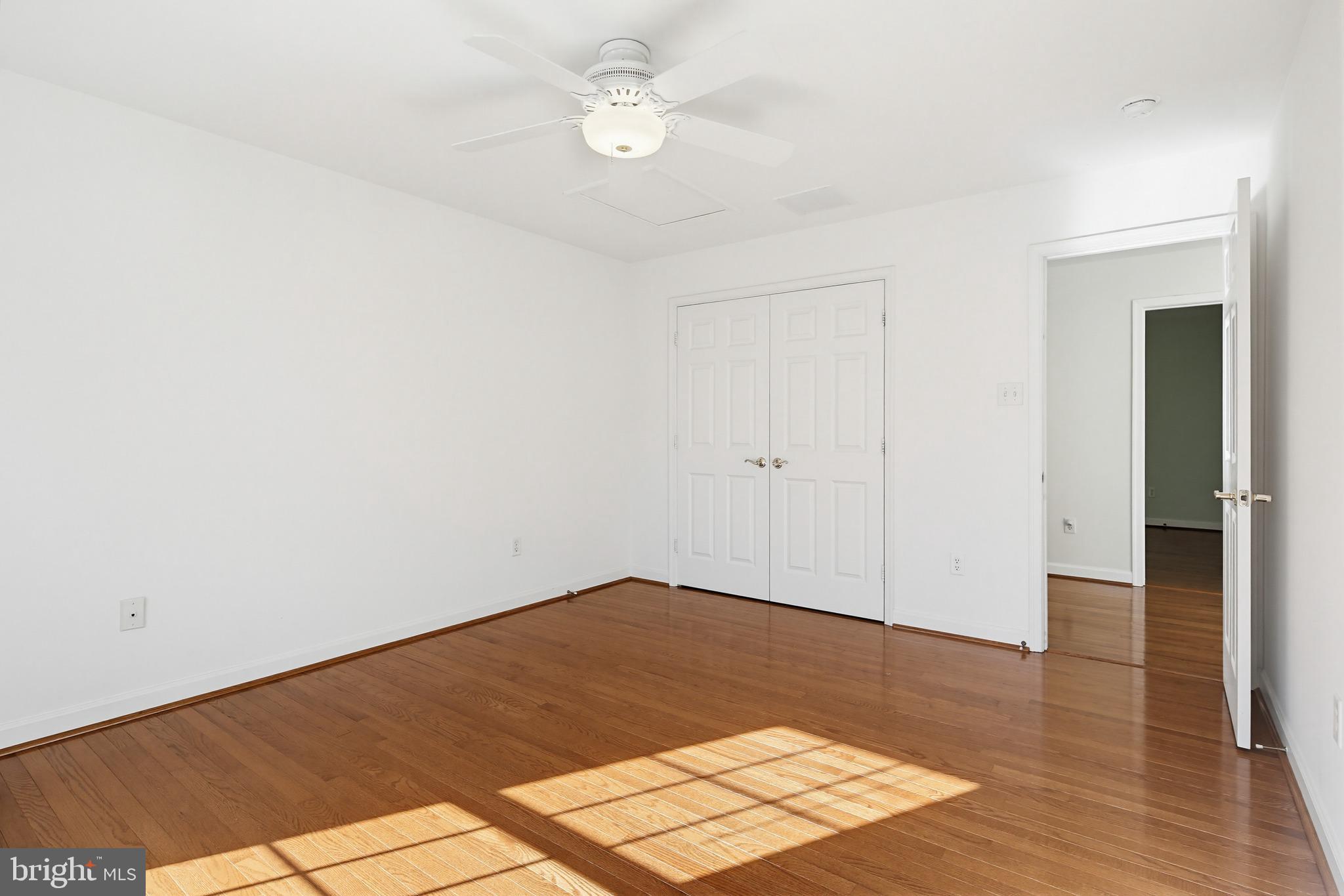12017 Floating Clouds Path Clarksville, MD 21029 - Photo 39 of 54 an empty room with wooden floor
