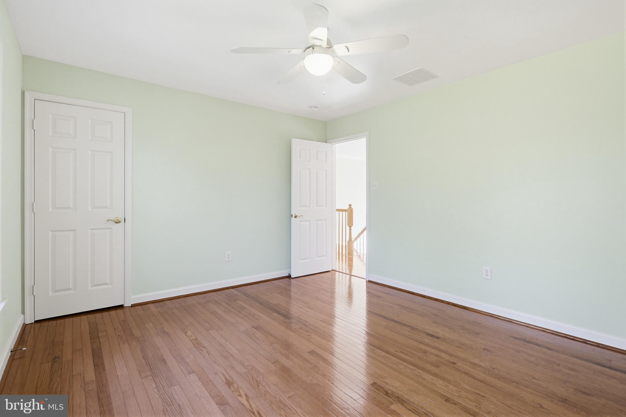 12017 Floating Clouds Path Clarksville, MD 21029 - Photo 40 of 54 a view of an empty room with wooden floor