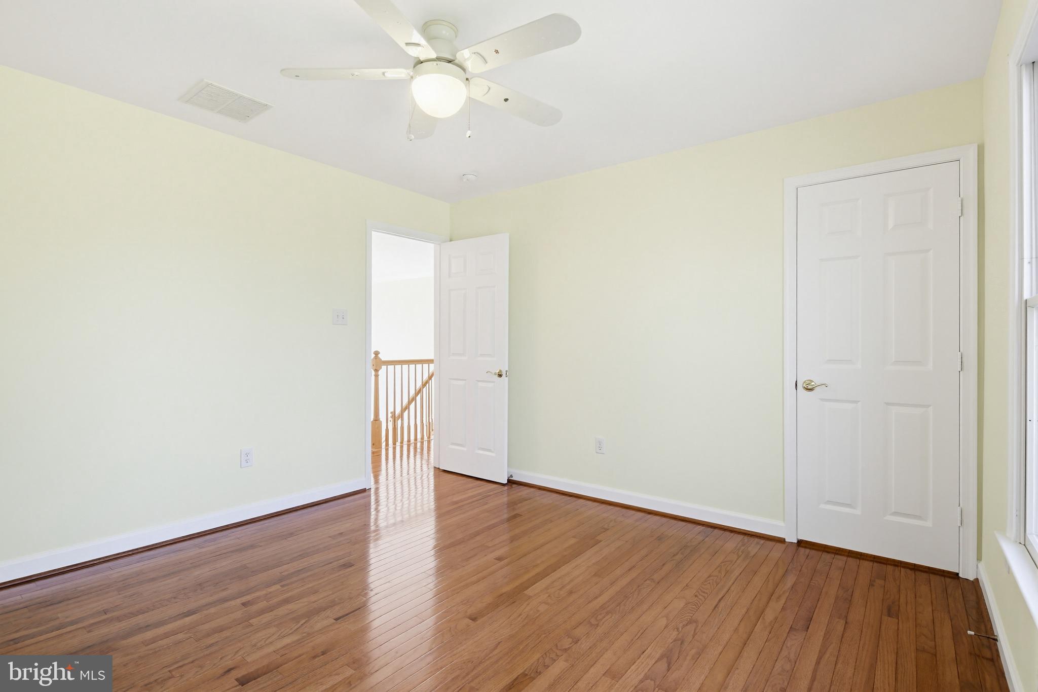 12017 Floating Clouds Path Clarksville, MD 21029 - Photo 42 of 54 an empty room with wooden floor and fan