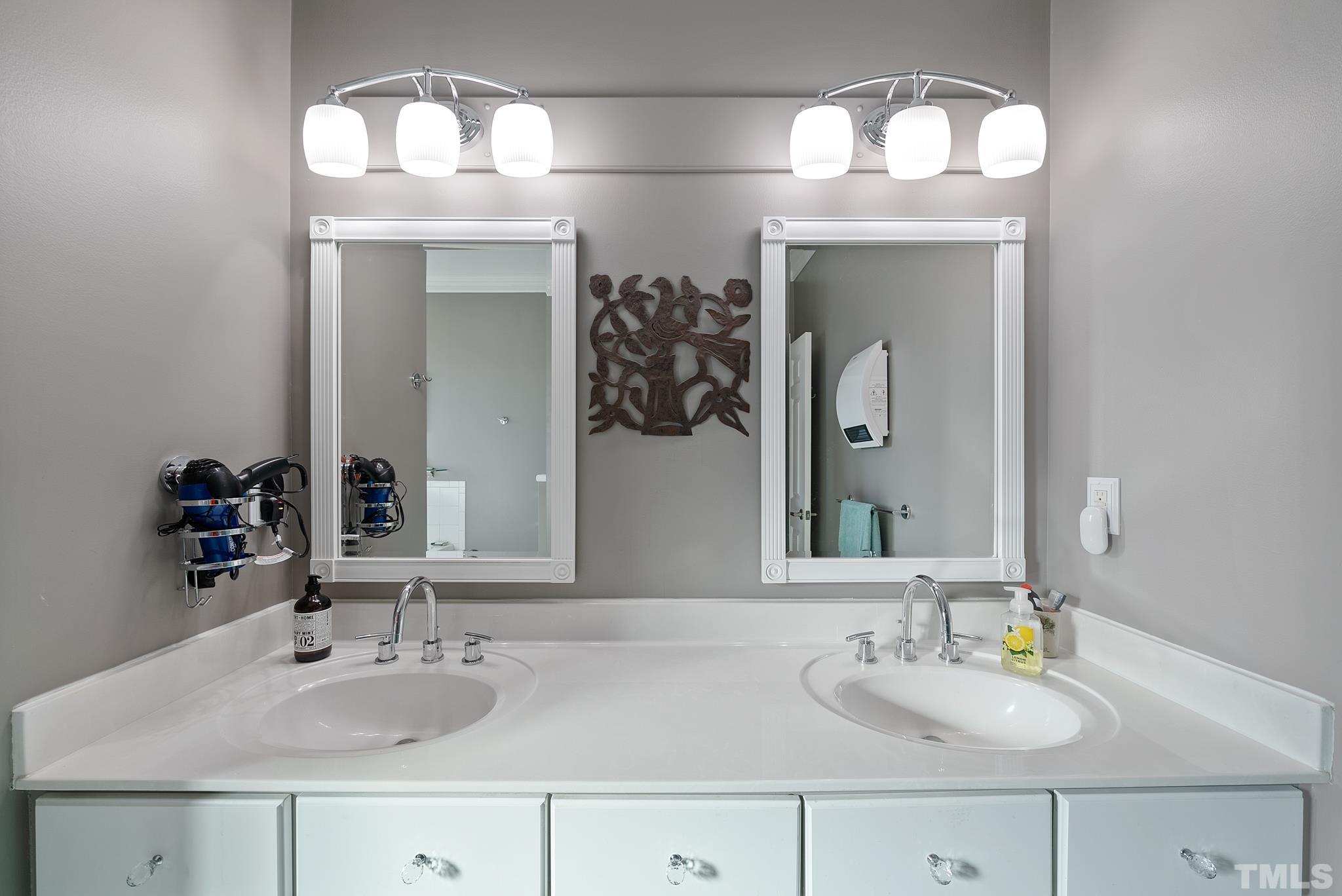 1616 Carl Durham Road Chapel Hill, NC 27516 - Photo 18 of 56 a bathroom with double vanity sinks and a mirror