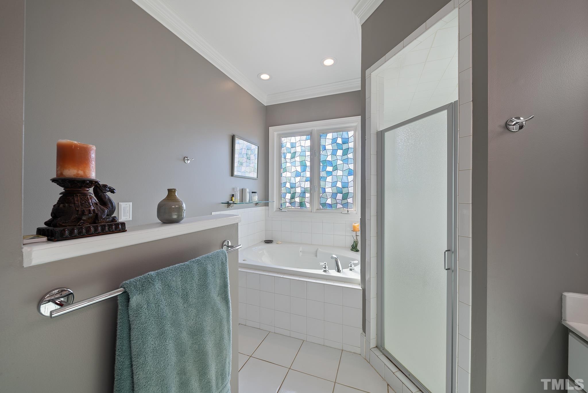 1616 Carl Durham Road Chapel Hill, NC 27516 - Photo 19 of 56 a bathroom with a tub sink and mirror