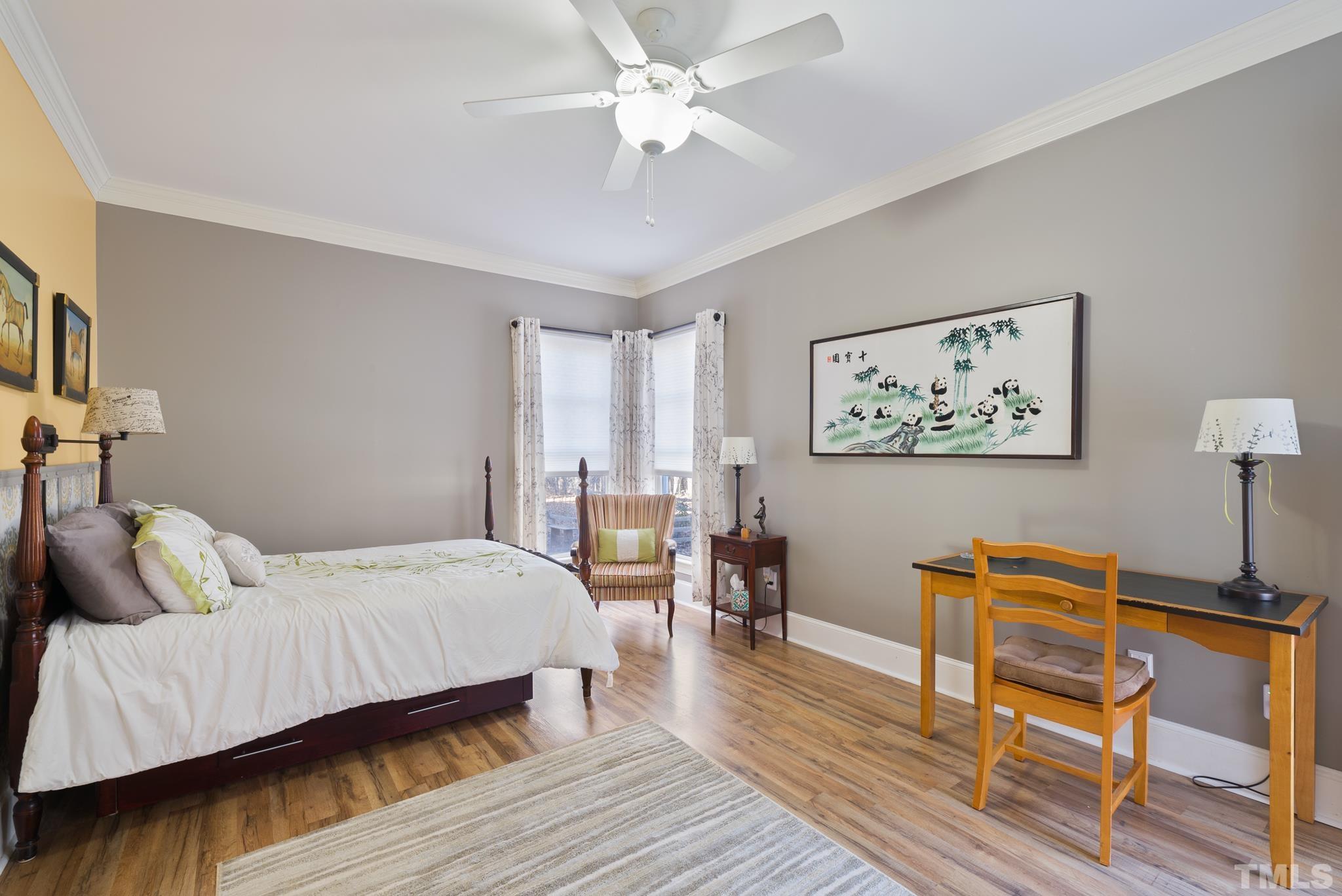 1616 Carl Durham Road Chapel Hill, NC 27516 - Photo 21 of 56 a bedroom with a bed and wooden floor