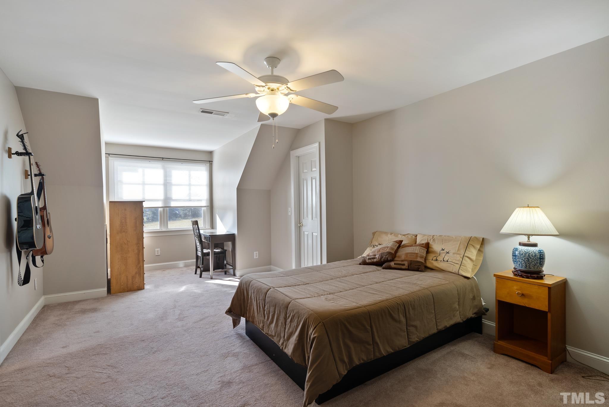 1616 Carl Durham Road Chapel Hill, NC 27516 - Photo 24 of 56 a bedroom with a bed and a chandelier