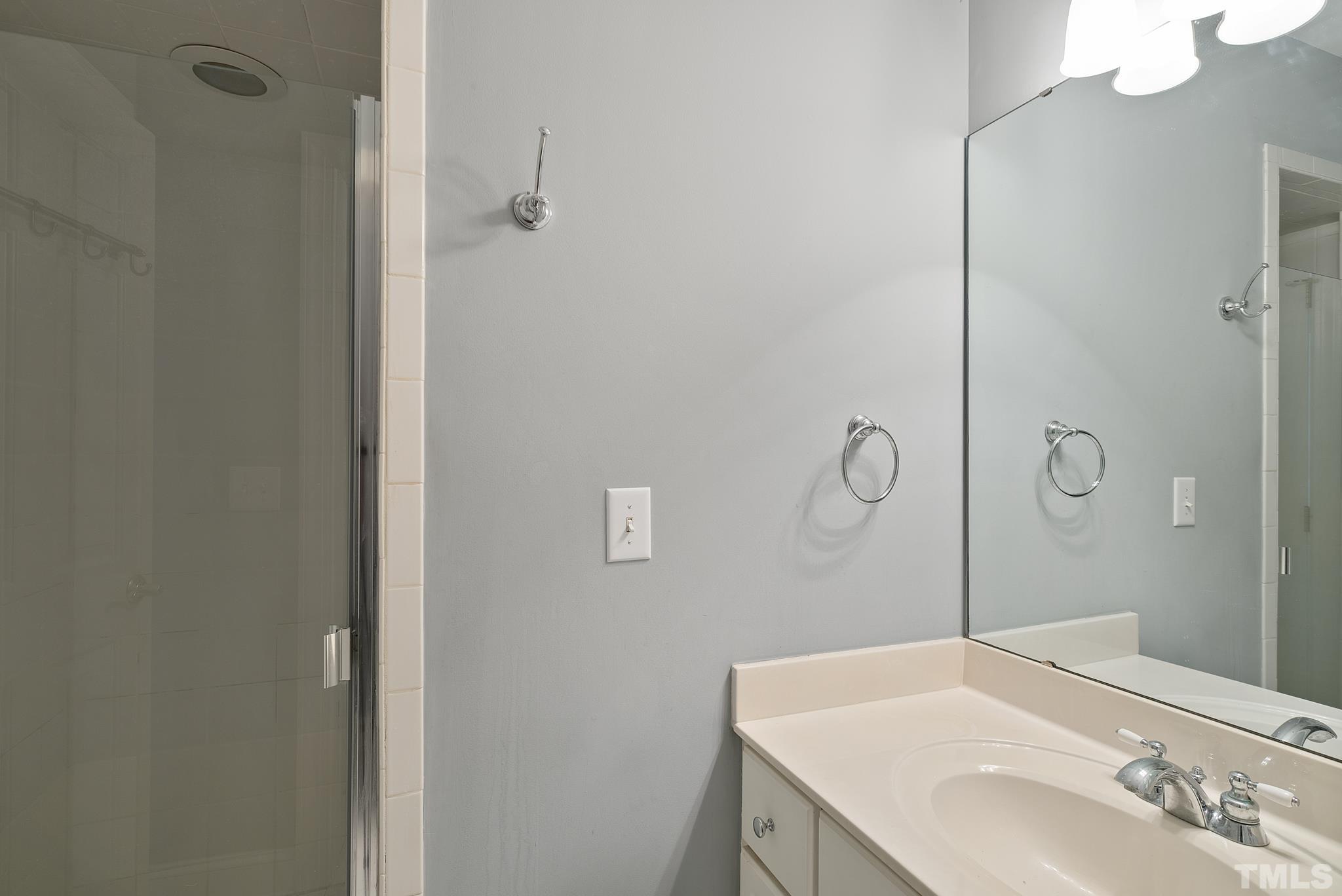 1616 Carl Durham Road Chapel Hill, NC 27516 - Photo 26 of 56 a bathroom with a sink vanity and a mirror