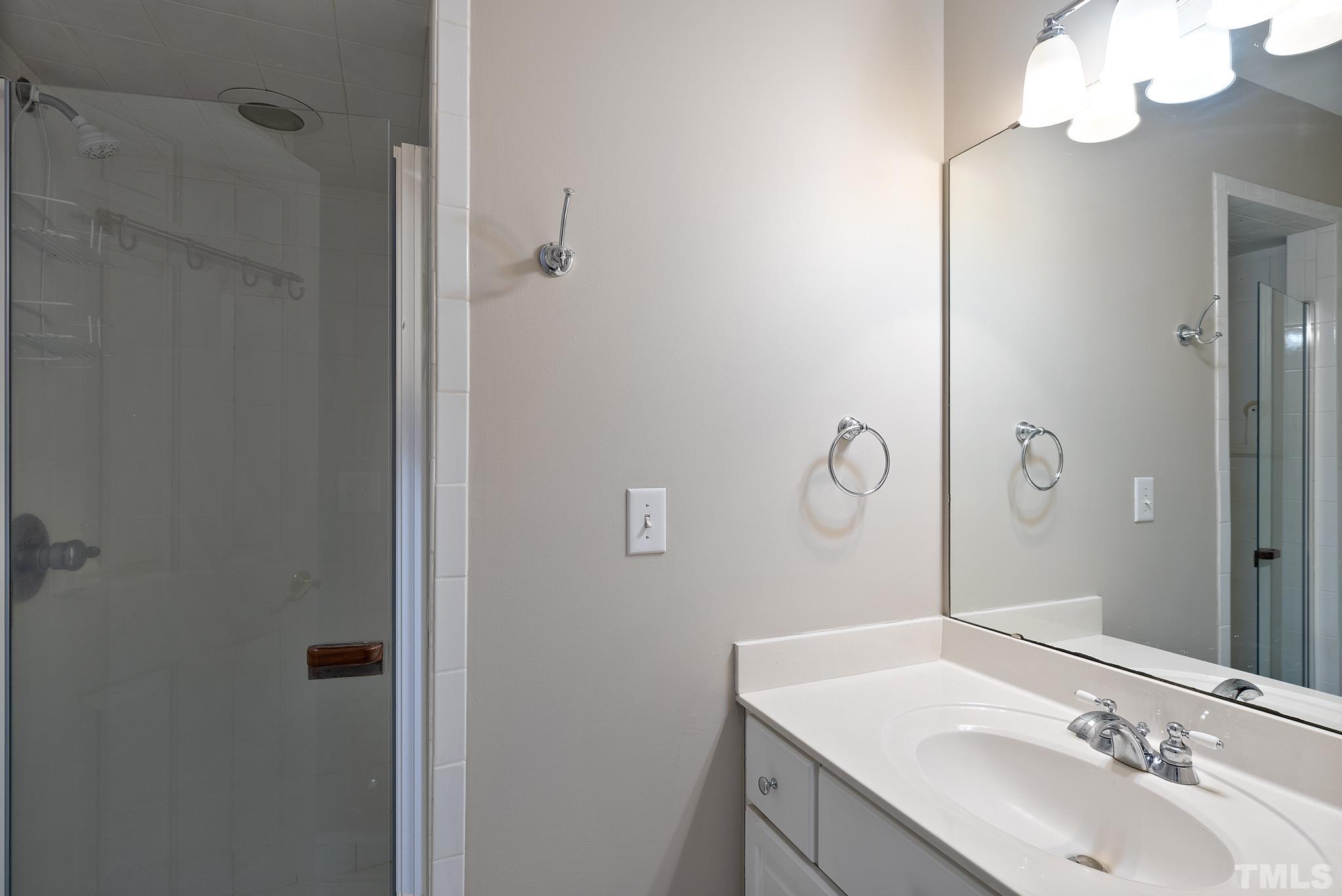 1616 Carl Durham Road Chapel Hill, NC 27516 - Photo 29 of 56 a bathroom with a sink vanity and mirror