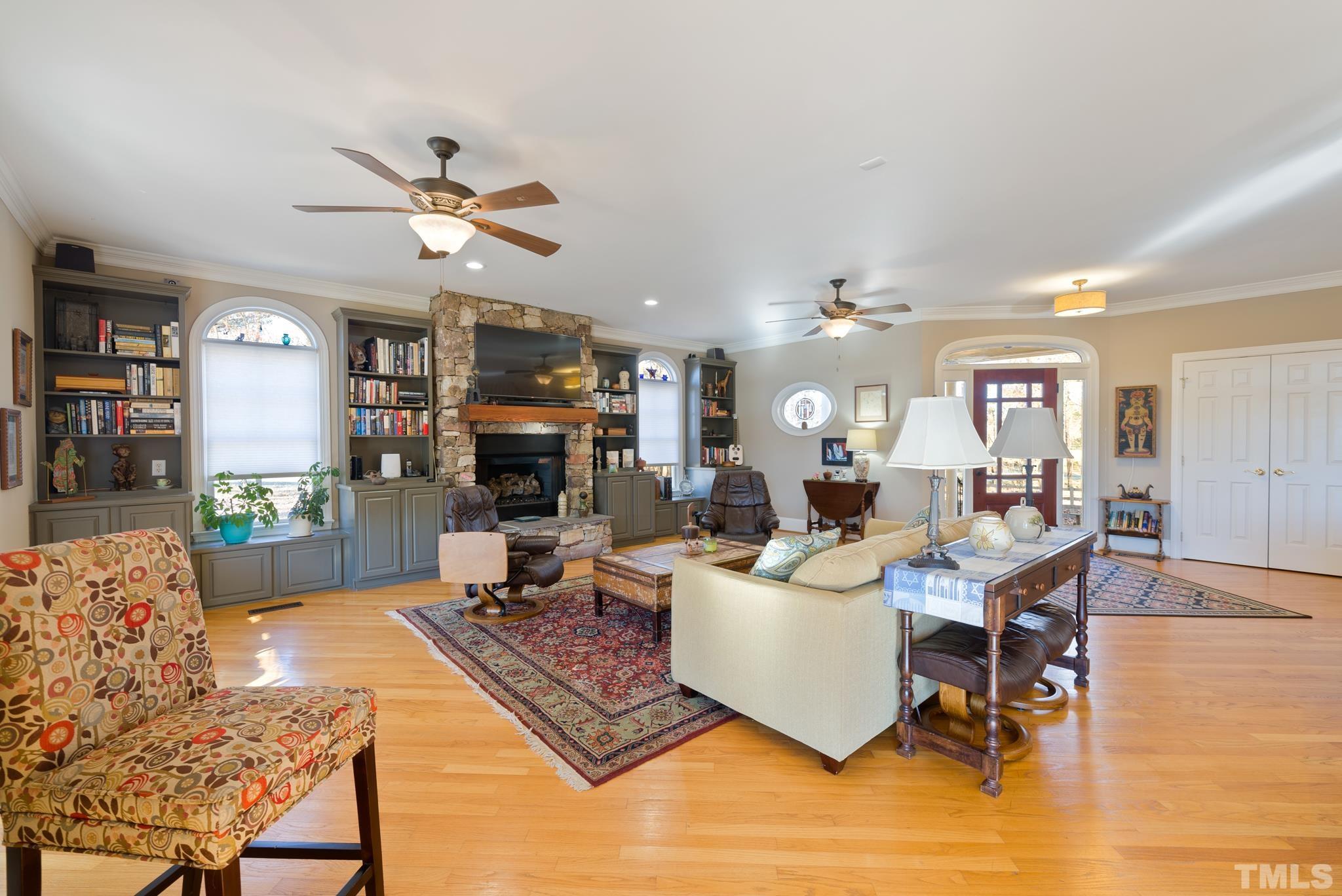 1616 Carl Durham Road Chapel Hill, NC 27516 - Photo 3 of 56 a living room with furniture a fireplace and a chandelier
