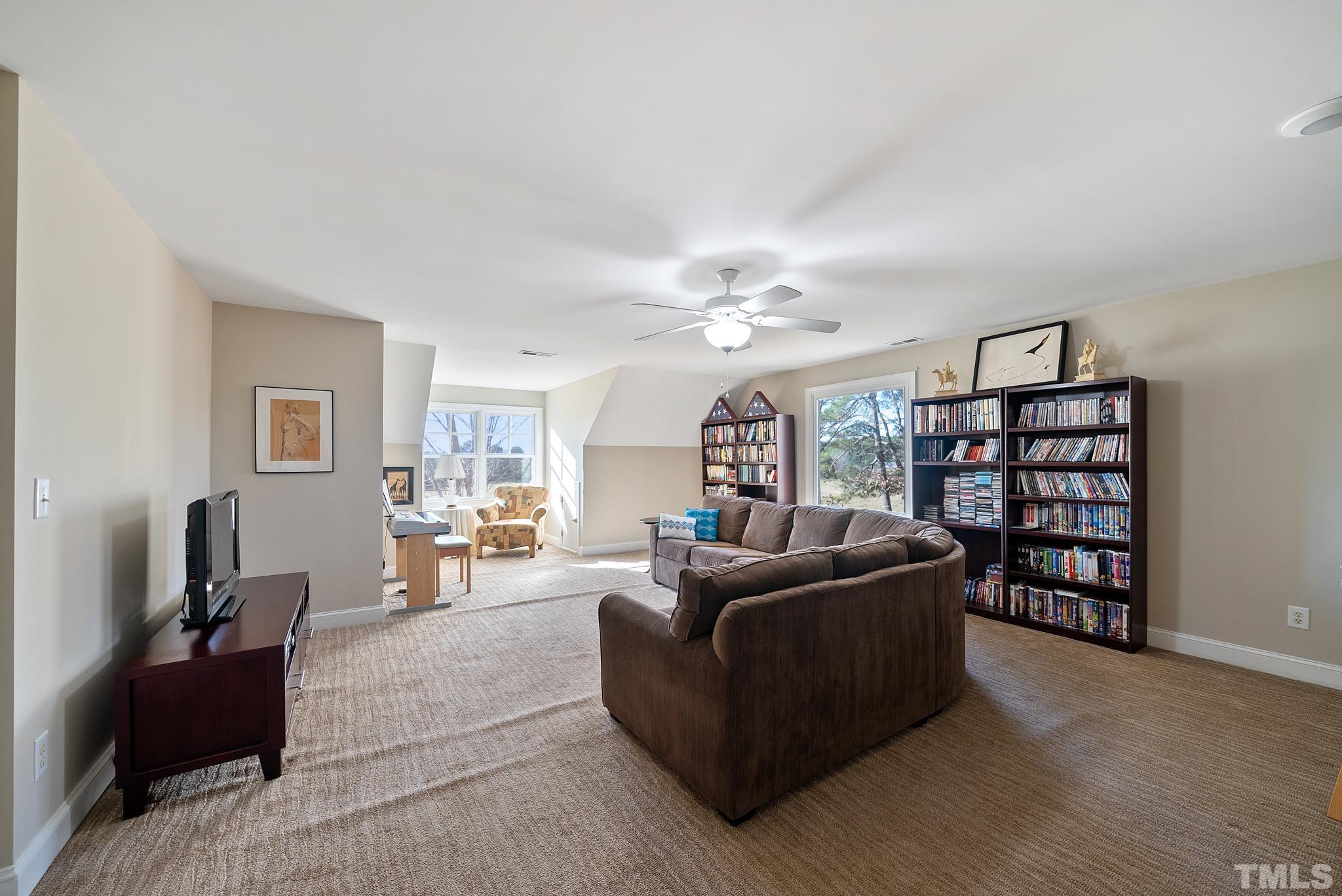 1616 Carl Durham Road Chapel Hill, NC 27516 - Photo 31 of 56 a living room with furniture and a bookshelf