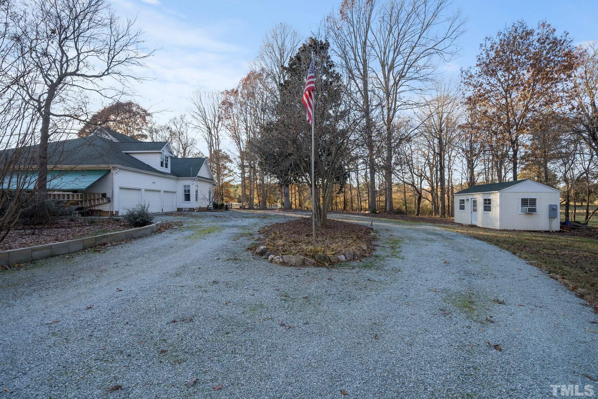 1616 Carl Durham Road Chapel Hill, NC 27516 - Photo 35 of 56 a front view of a house with a yard and garage