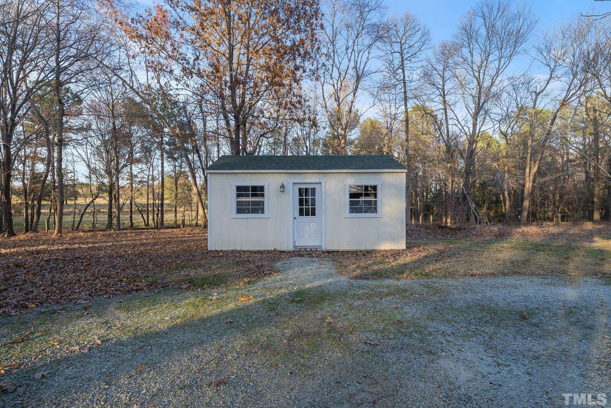 1616 Carl Durham Road Chapel Hill, NC 27516 - Photo 41 of 56 a view of a house with a yard covered in the forest