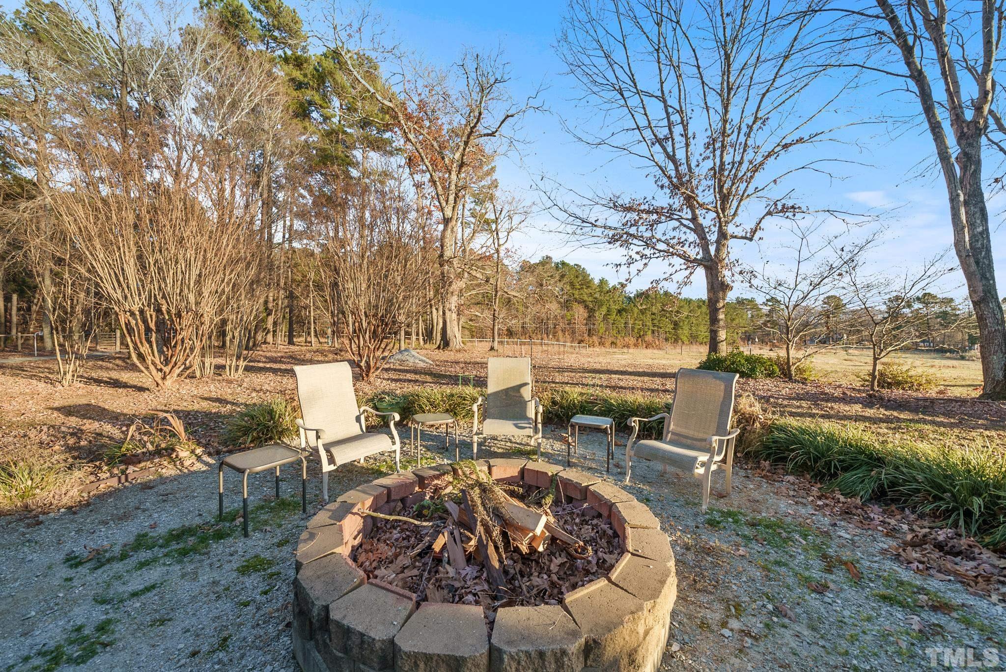 1616 Carl Durham Road Chapel Hill, NC 27516 - Photo 50 of 56 a view of a patio with table and chairs under an umbrella