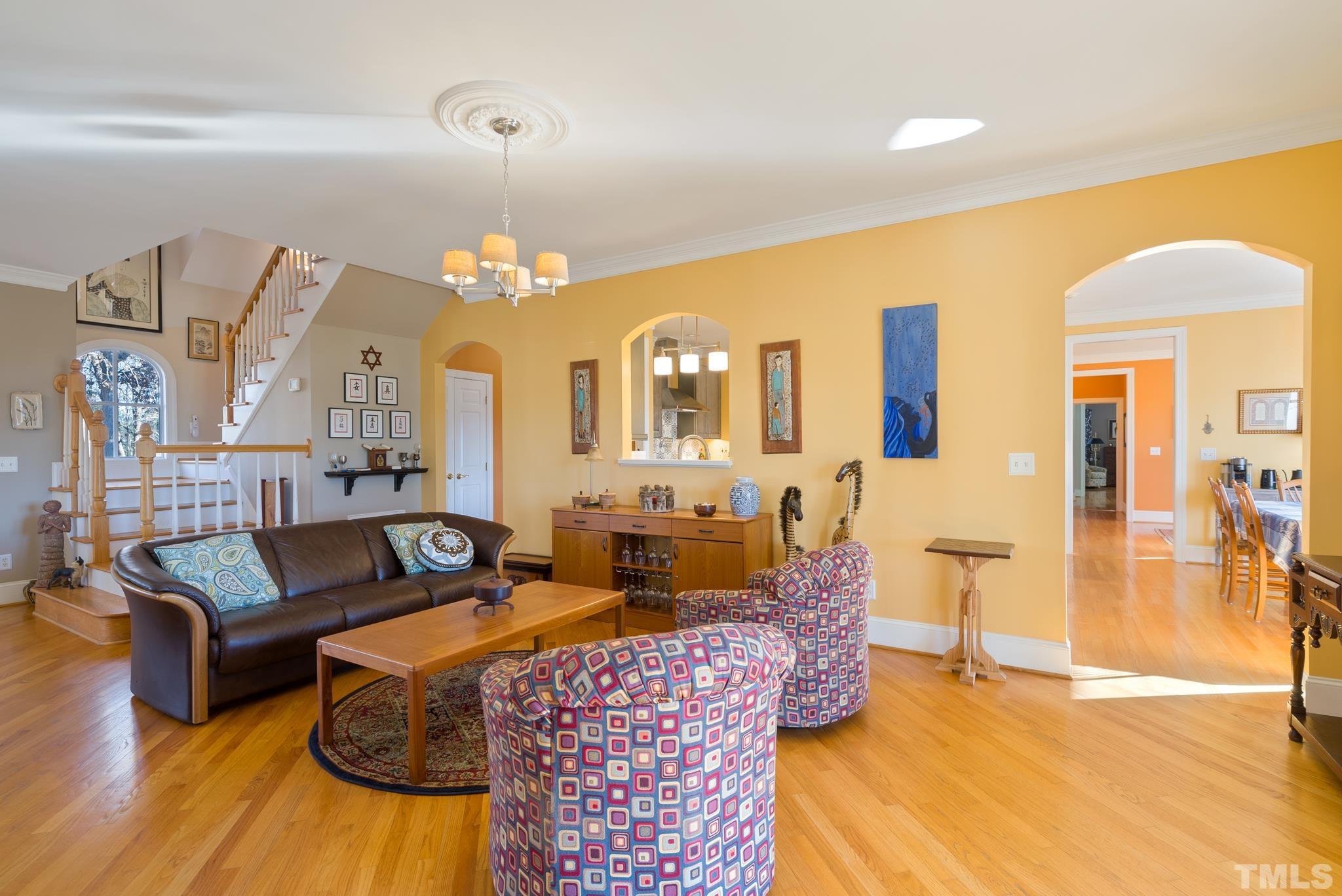 1616 Carl Durham Road Chapel Hill, NC 27516 - Photo 6 of 56 a living room with furniture chandelier and a chandelier