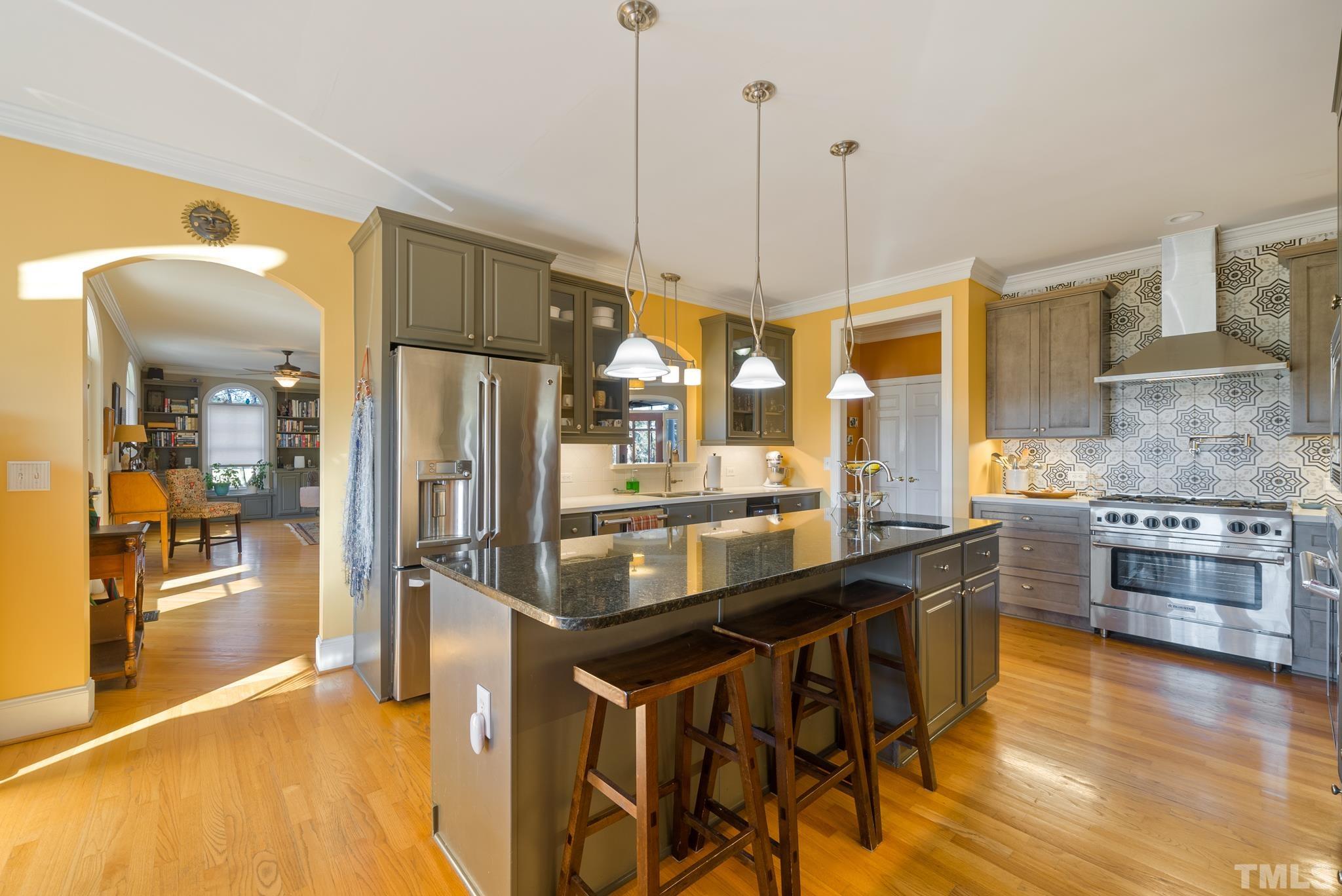 1616 Carl Durham Road Chapel Hill, NC 27516 - Photo 7 of 56 a kitchen with stainless steel appliances granite countertop a stove a refrigerator a sink a oven and a wooden cabinets