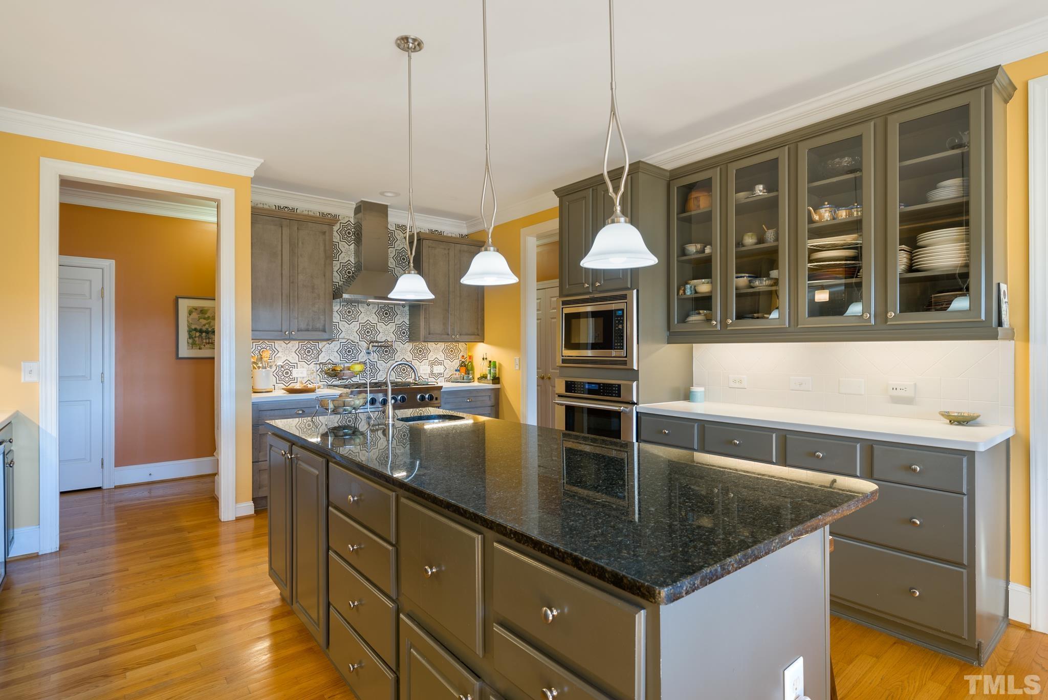 1616 Carl Durham Road Chapel Hill, NC 27516 - Photo 9 of 56 a kitchen with stainless steel appliances granite countertop a sink a stove and a wooden floors