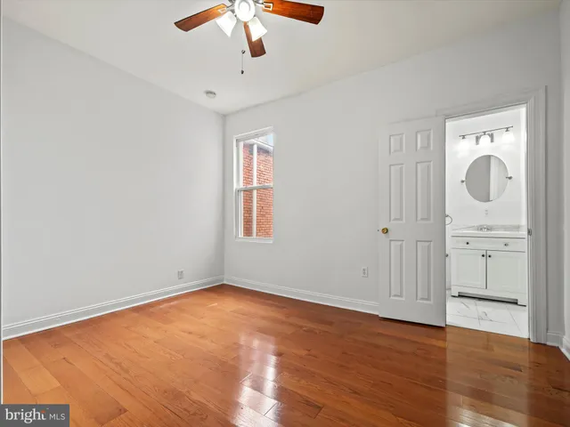 a bedroom with bed and a chandelier