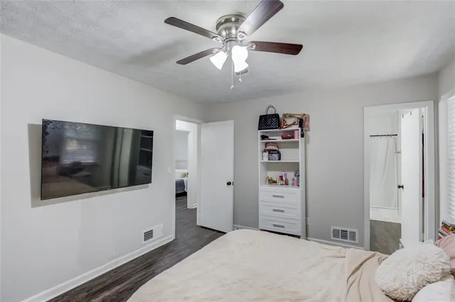 a bedroom with a large bed and a flat screen tv