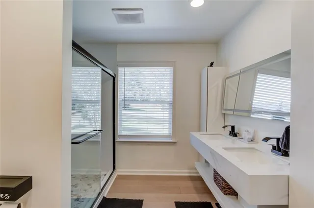 a bathroom with a sink a toilet and a mirror