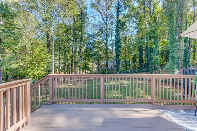 a view of a small yard and large trees