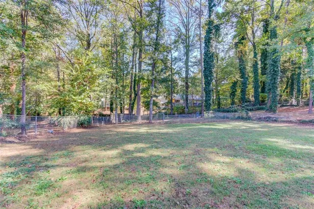 a view of a park that has large trees