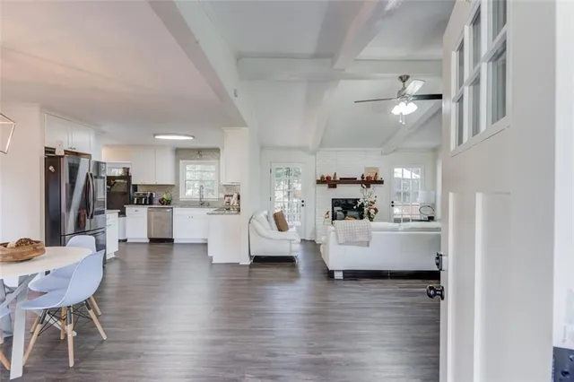 a living room with kitchen island furniture and a wooden floor