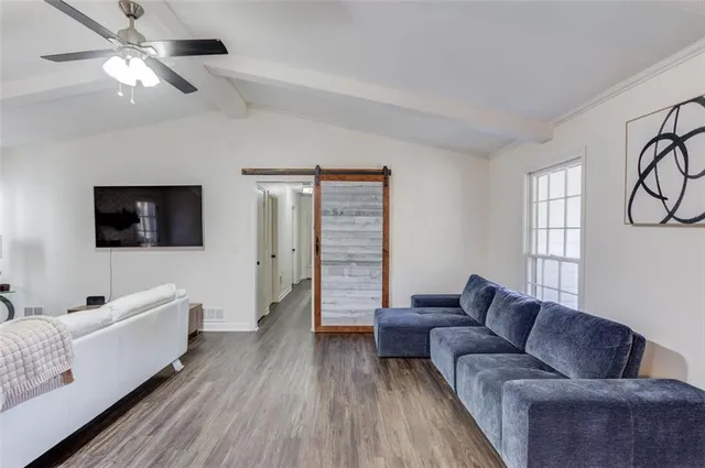 a living room with furniture and a flat screen tv