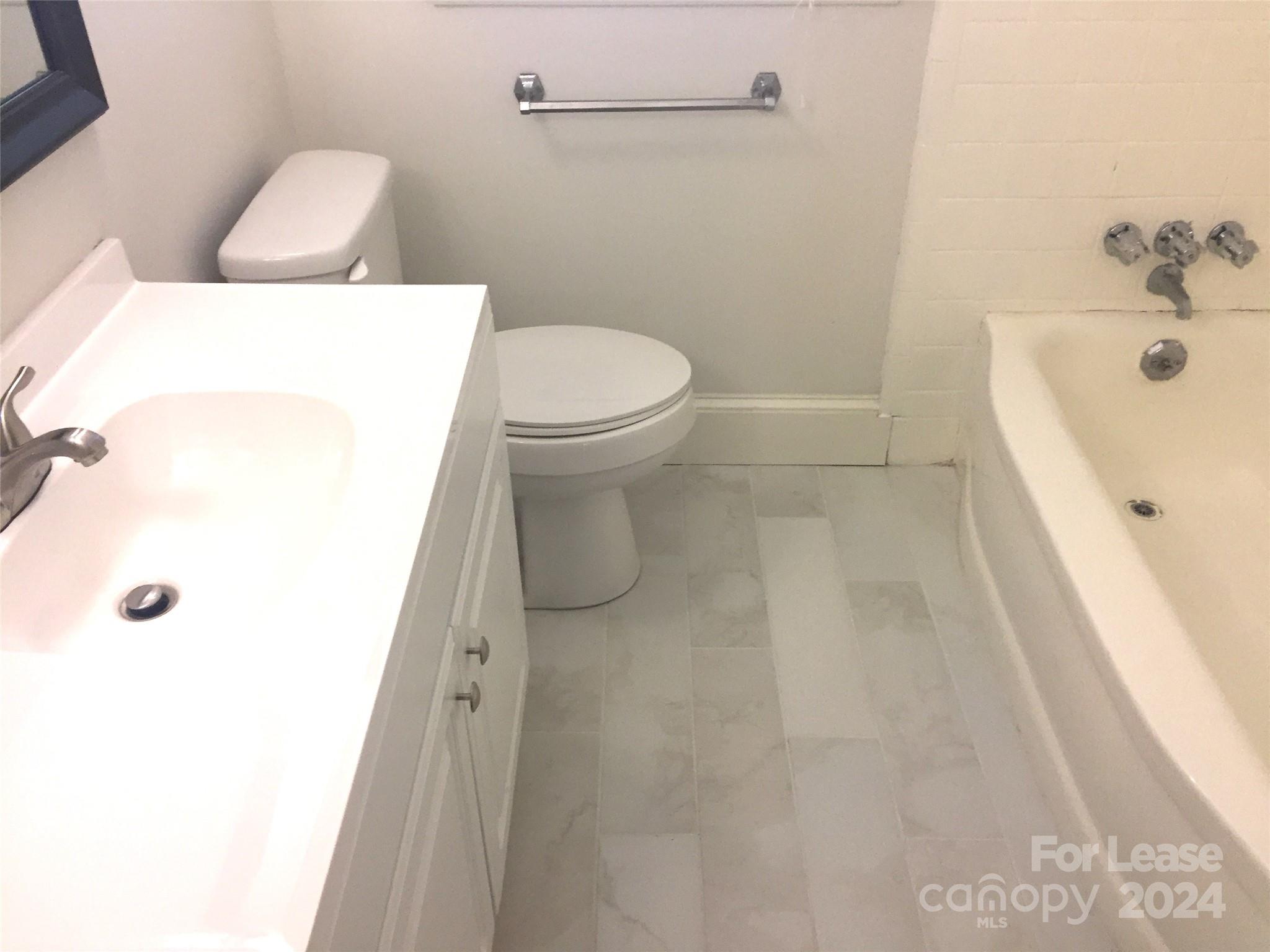 1824 Club Road Charlotte, NC 28205 - Photo 11 of 11 a bathroom with a sink a toilet and shower