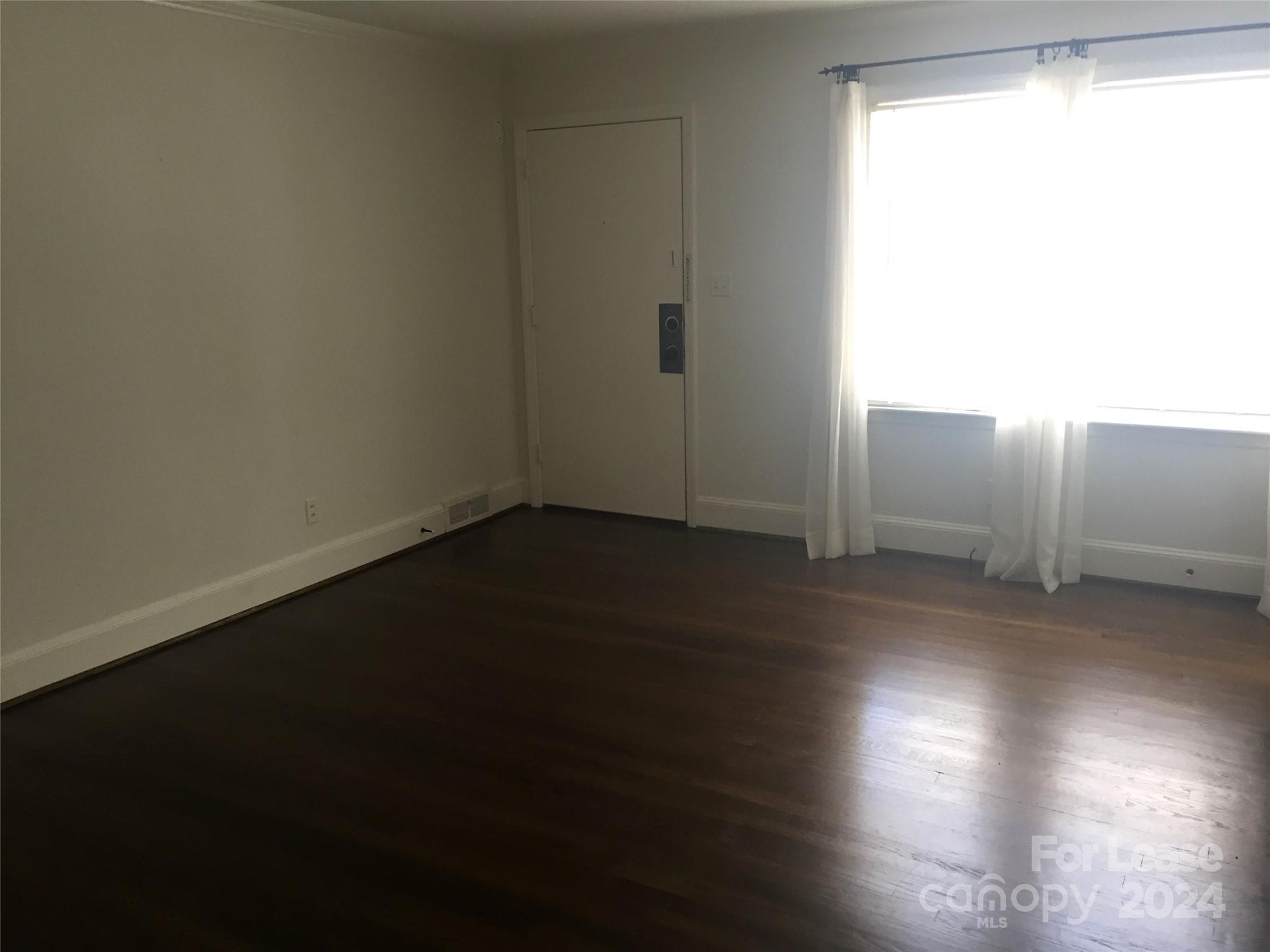 1824 Club Road Charlotte, NC 28205 - Photo 2 of 11 a view of a livingroom with wooden floor and a window