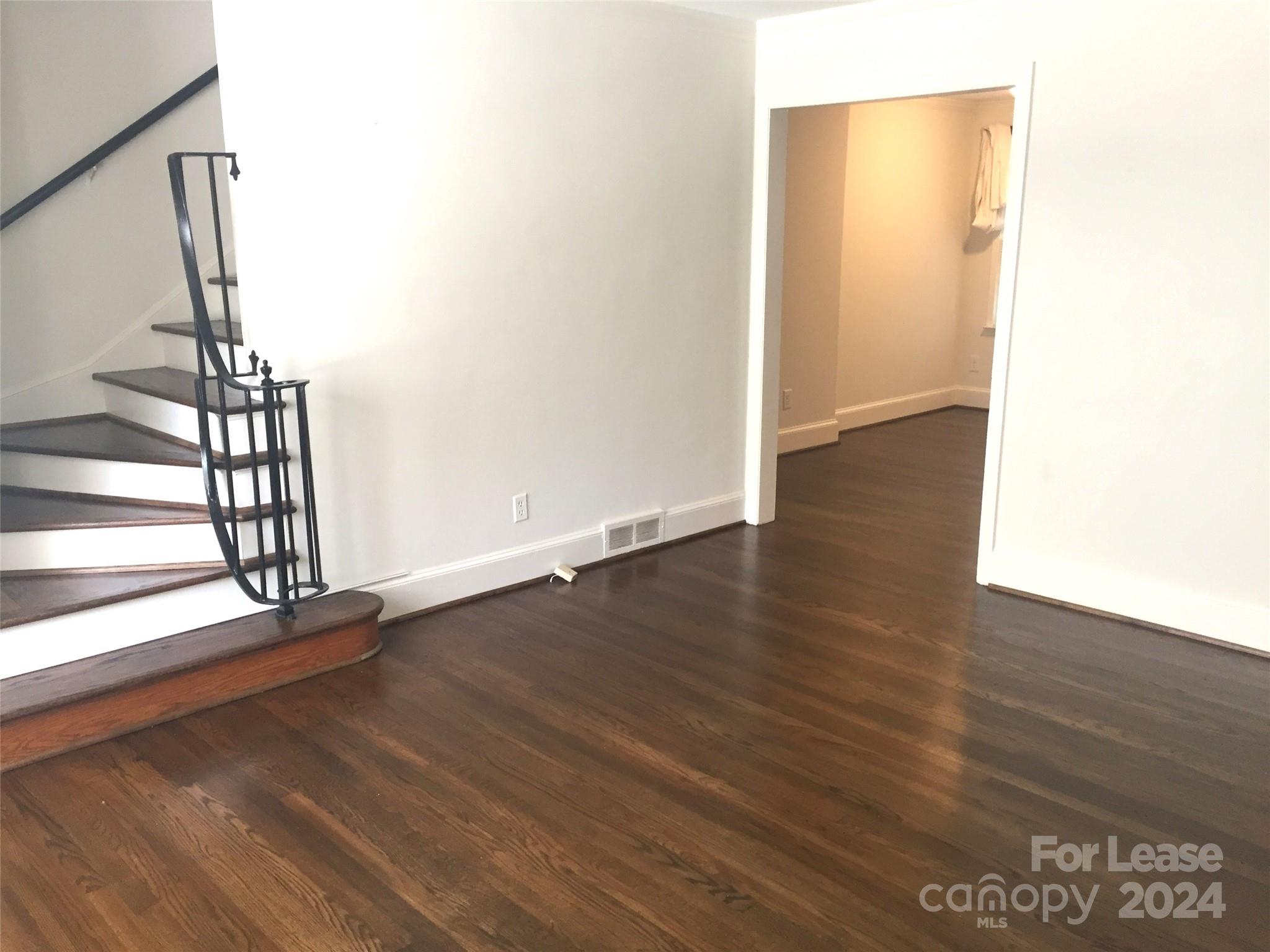 1824 Club Road Charlotte, NC 28205 - Photo 3 of 11 a view of an empty room with wooden floor and a window