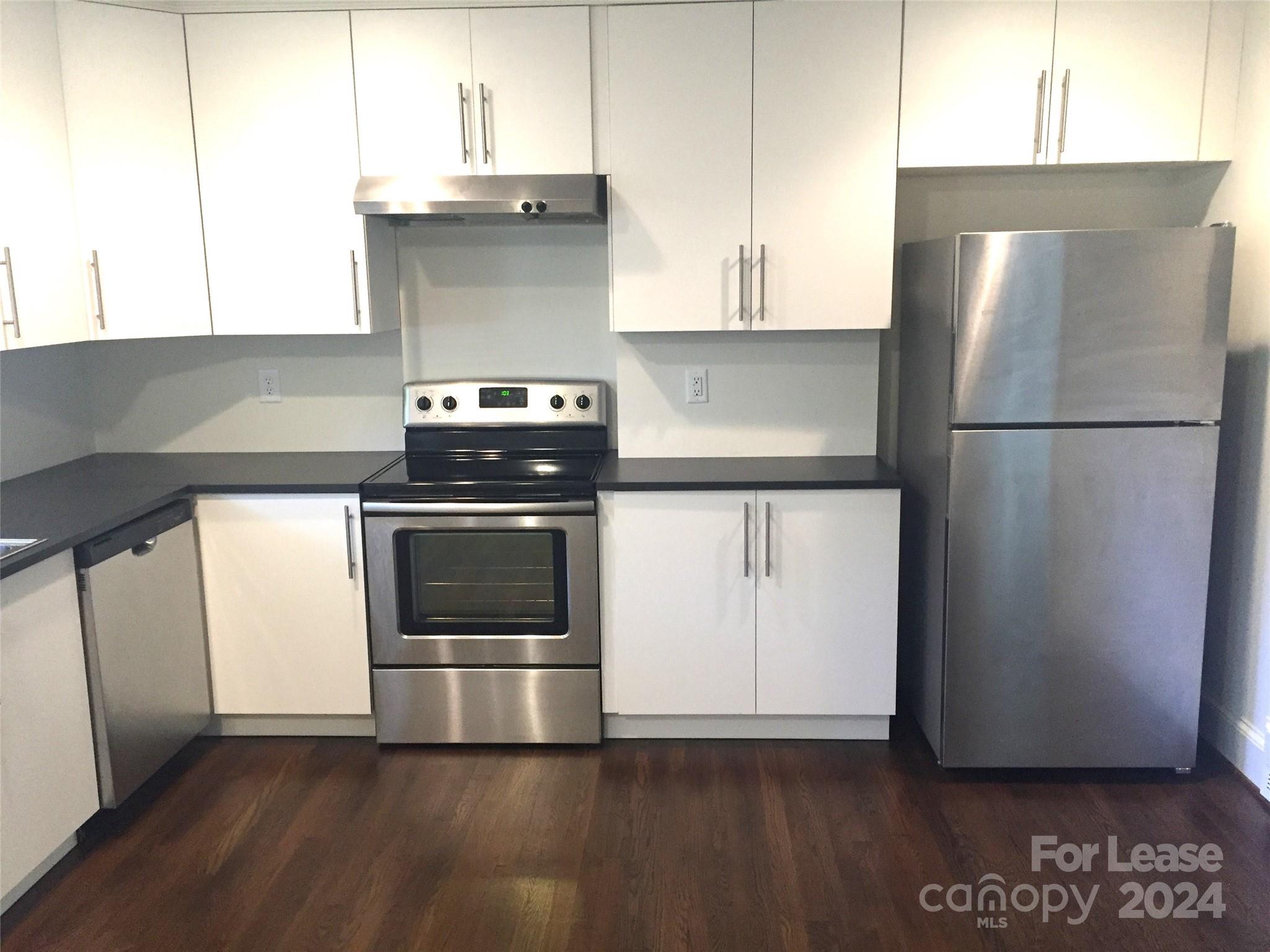 1824 Club Road Charlotte, NC 28205 - Photo 6 of 11 a kitchen with a stove top oven and refrigerator