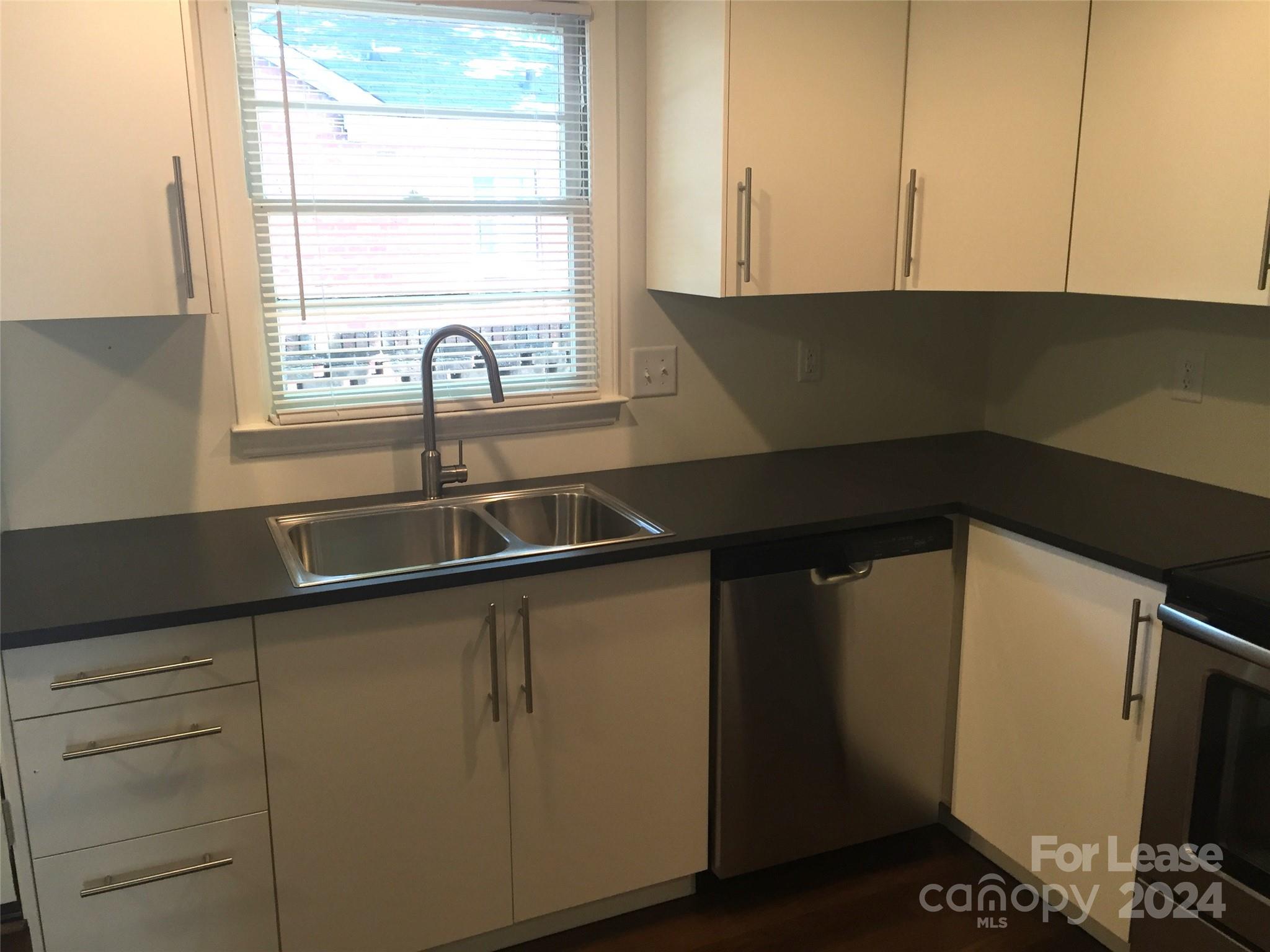 1824 Club Road Charlotte, NC 28205 - Photo 7 of 11 a kitchen with a sink and a window