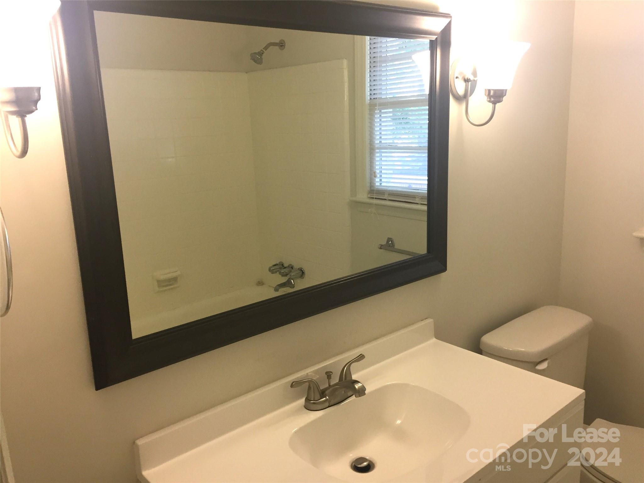 1824 Club Road Charlotte, NC 28205 - Photo 10 of 11 a bathroom with a sink and a mirror