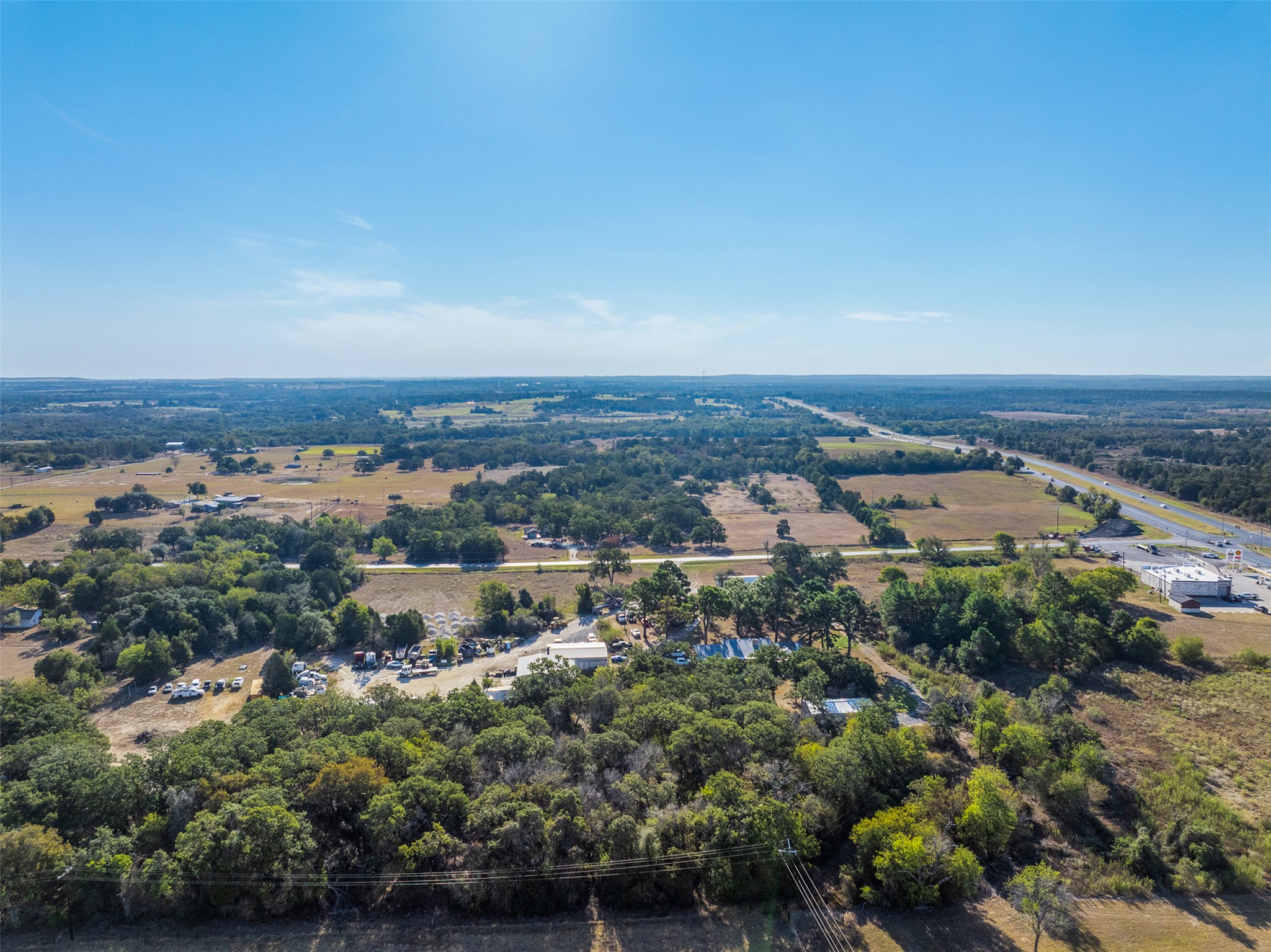 139 Farm To Market 696 Elgin, TX 78621 - Photo 19 of 27 Drone / aerial view of a tree filled landscape