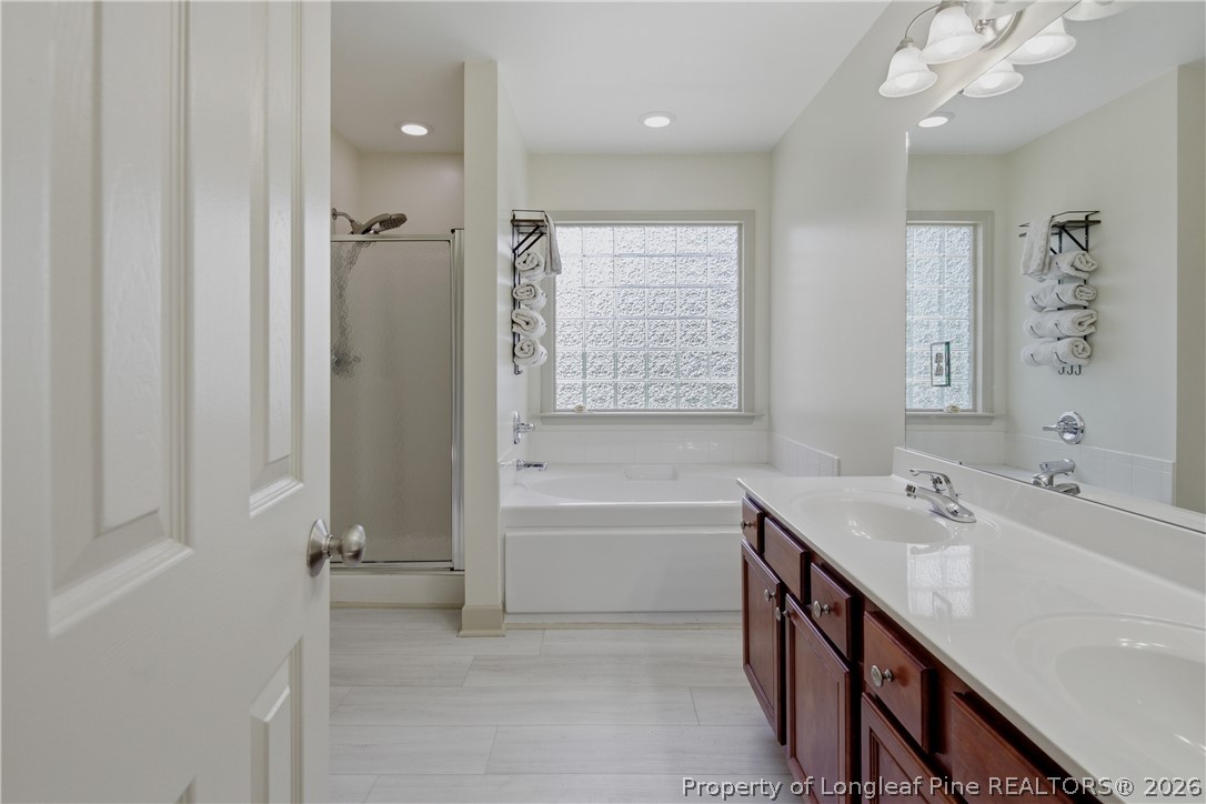 1075 Buffalo Lake Road Sanford, NC 27332 - Photo 30 of 49 a spacious bathroom with a tub sink and mirror