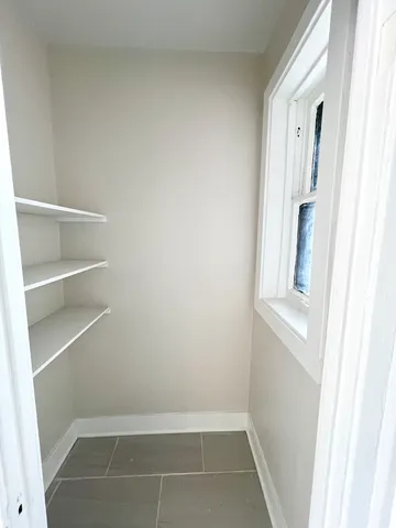 a kitchen with stainless steel appliances granite countertop a refrigerator a stove a sink and white cabinets