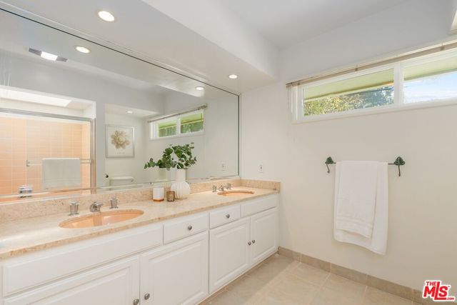 a bathroom with a granite countertop sink mirror and double