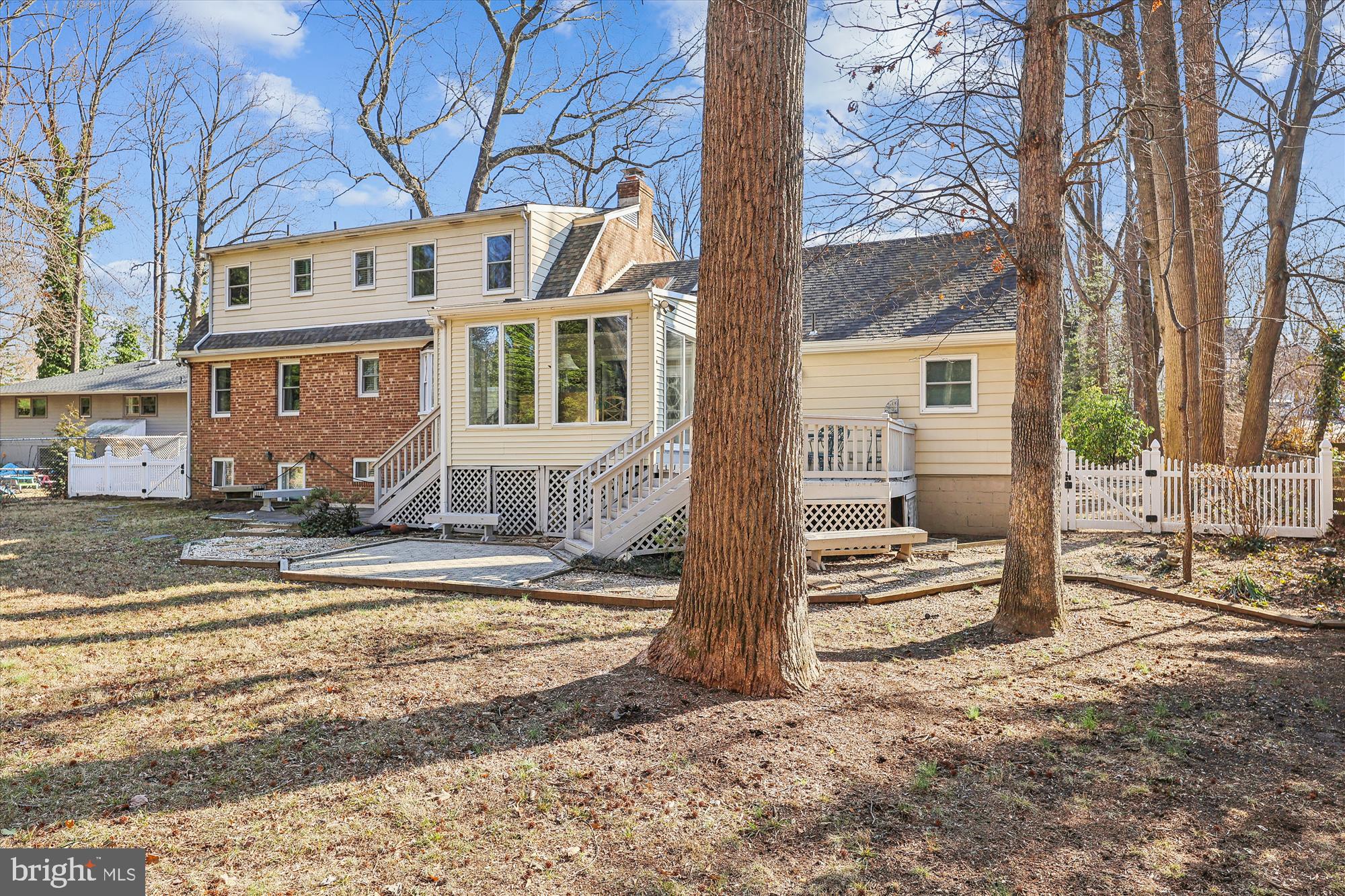 9010 Spring Avenue Lanham, MD 20706 - Photo 34 of 36 Backyard view of the house with deck and sunroom