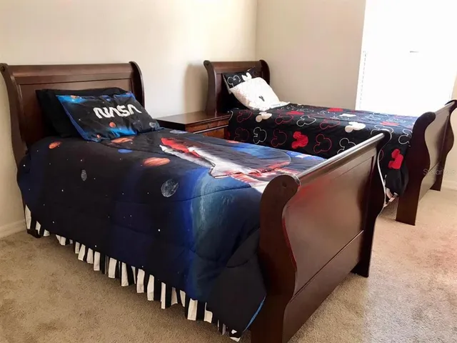 a bedroom with bed and a window