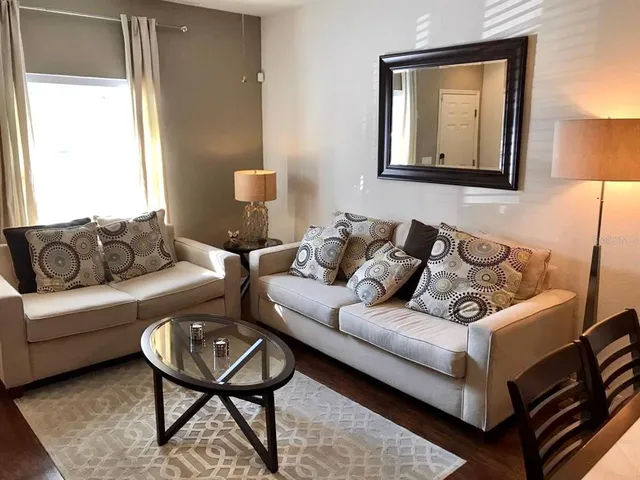 a living room with furniture and a window