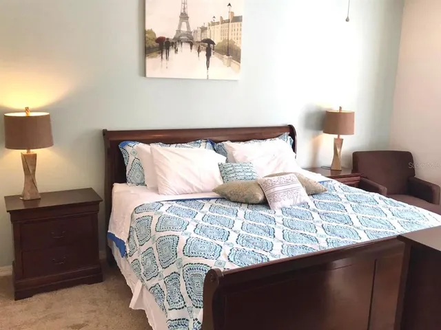 a bedroom with a bed and a lamp
