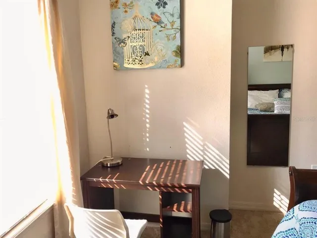 a bedroom with a bed and a night stand