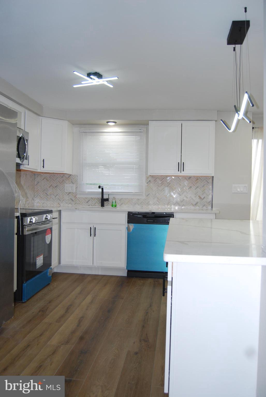 2400 Ridgely Street Baltimore, MD 21230 - Photo 5 of 20 a kitchen with kitchen island a sink stainless steel appliances and cabinets