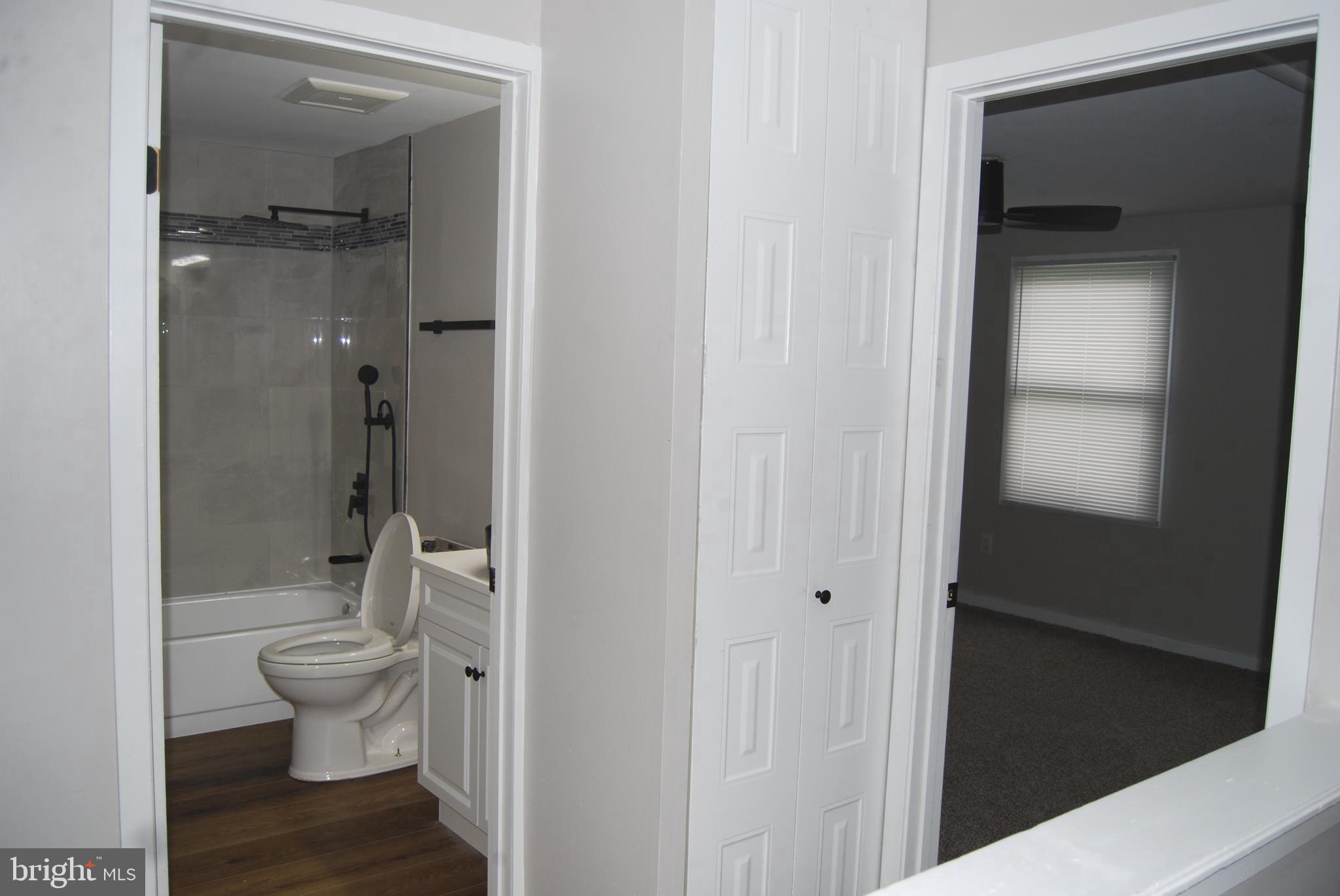 2400 Ridgely Street Baltimore, MD 21230 - Photo 8 of 20 a bathroom with a granite countertop toilet and a sink
