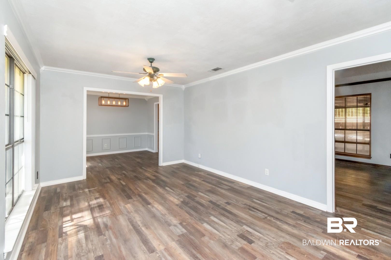 8304 Champlain Circle Mobile, AL 36695 - Photo 7 of 46 Unfurnished room with ceiling fan, ornamental molding, and dark hardwood / wood-style flooring