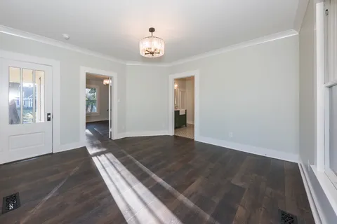 a view of an empty room and wooden floor