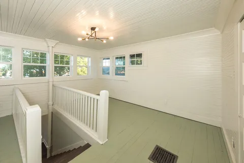 a view of a hallway with windows