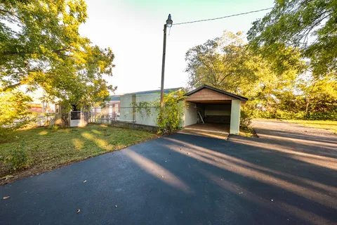 a view of a house with a yard and garage